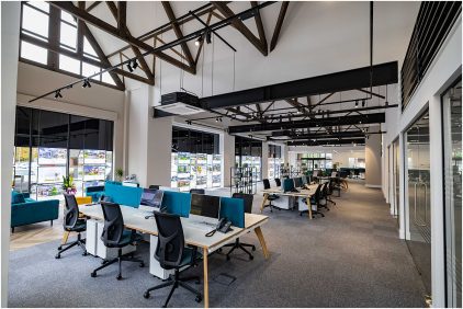 Indoor image of a modern, open-plan office with desks and chairs.