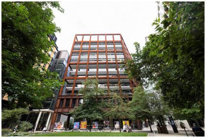 Outdoor image of a modern office building surrounded by greenery.