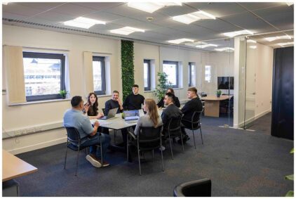 Indoor image of a group of people having a meeting in a modern office.