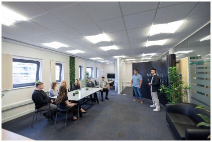 Indoors image of a group of people having a meeting in a modern office.