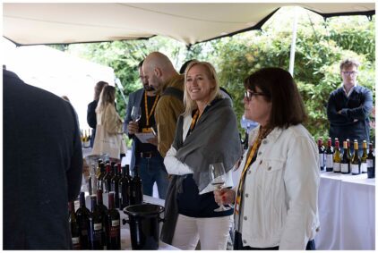 Outdoor image of people enjoying a wine tasting event.